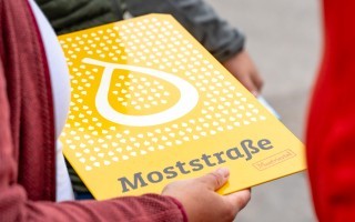 Pressefoto-3-Moststraße-in-neuem-Gewand_Moststraße-Mitgliedsbetriebstafel_c-Gleanhill-Studios.jpg